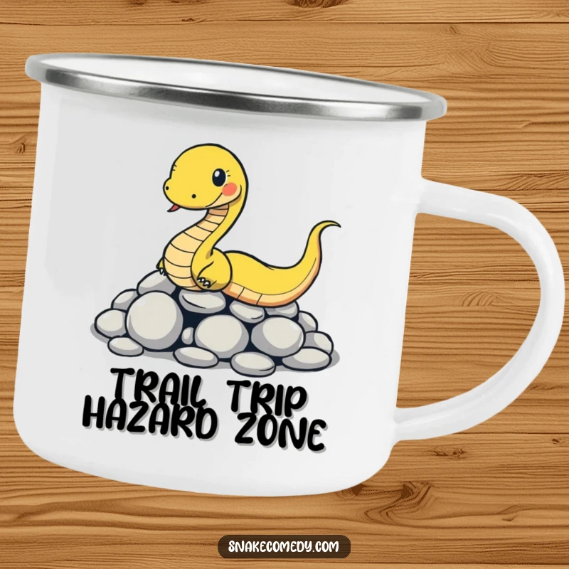 Funny snake camping mug with a cartoon snake comically slipping on smooth round stones, ideal for humorous outdoor excursions.