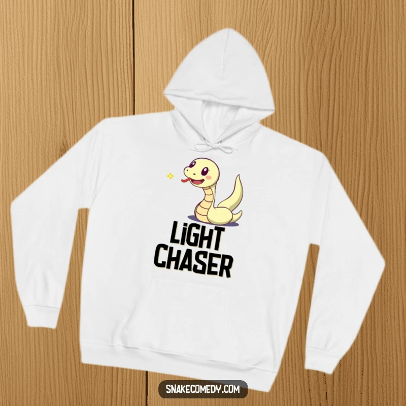 Funny hoodie illustrating an excited snake character with an extended tongue, actively chasing a dancing speck of light.
