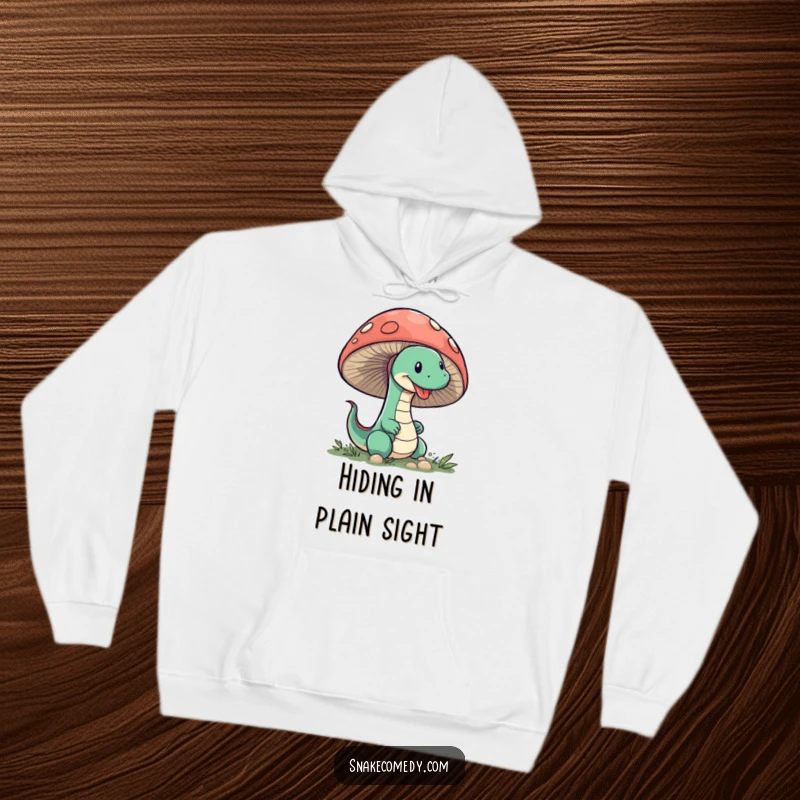 Funny Snake Mushroom Hoodie: A funny illustration of a sneaky snake peeking from behind a large mushroom, perfect for cozy moments.
