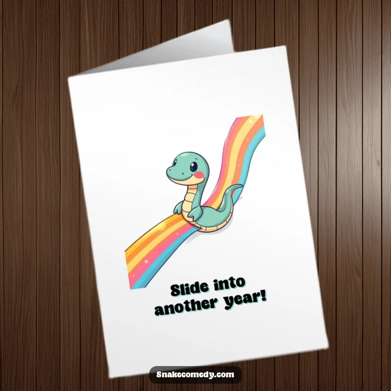 Funny Free Printable Birthday Card: A snake comically slides down a vibrant, shimmering rainbow ribbon.