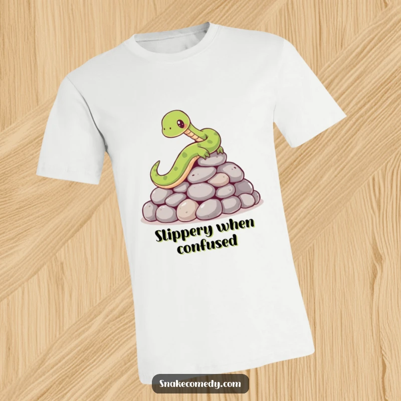 Funny t-shirt with a cartoon snake comically failing to keep its balance while slipping on a heap of smooth, round stones.
