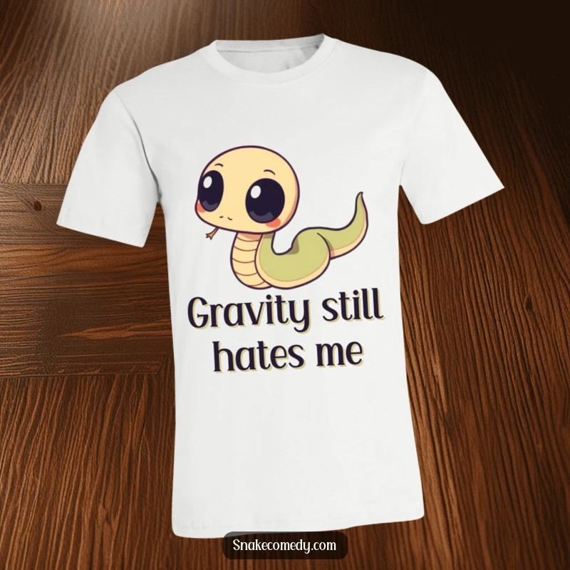 Funny snake with big, round eyes caught in a comical moment of tripping over its own tail on a humorous t-shirt.
